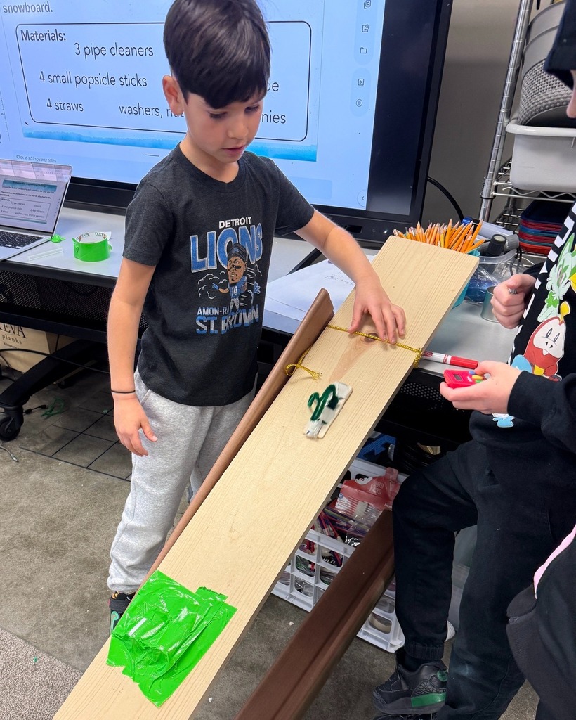 student releases snowboard creation down wooden slope