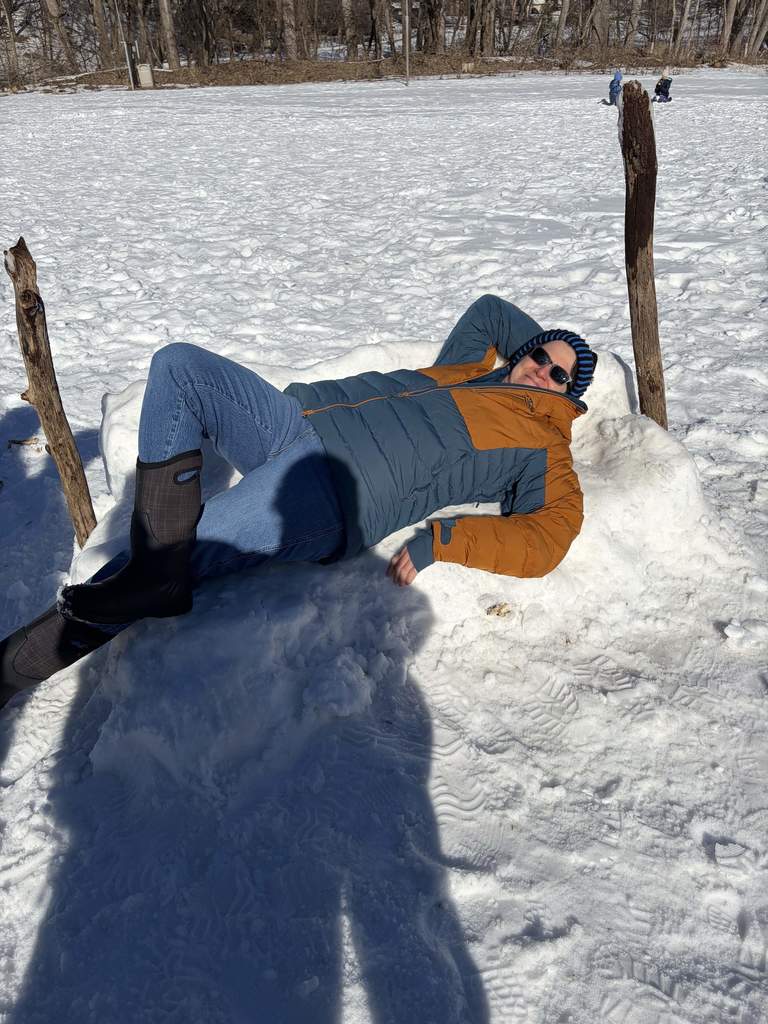 teacher lies on snow couch