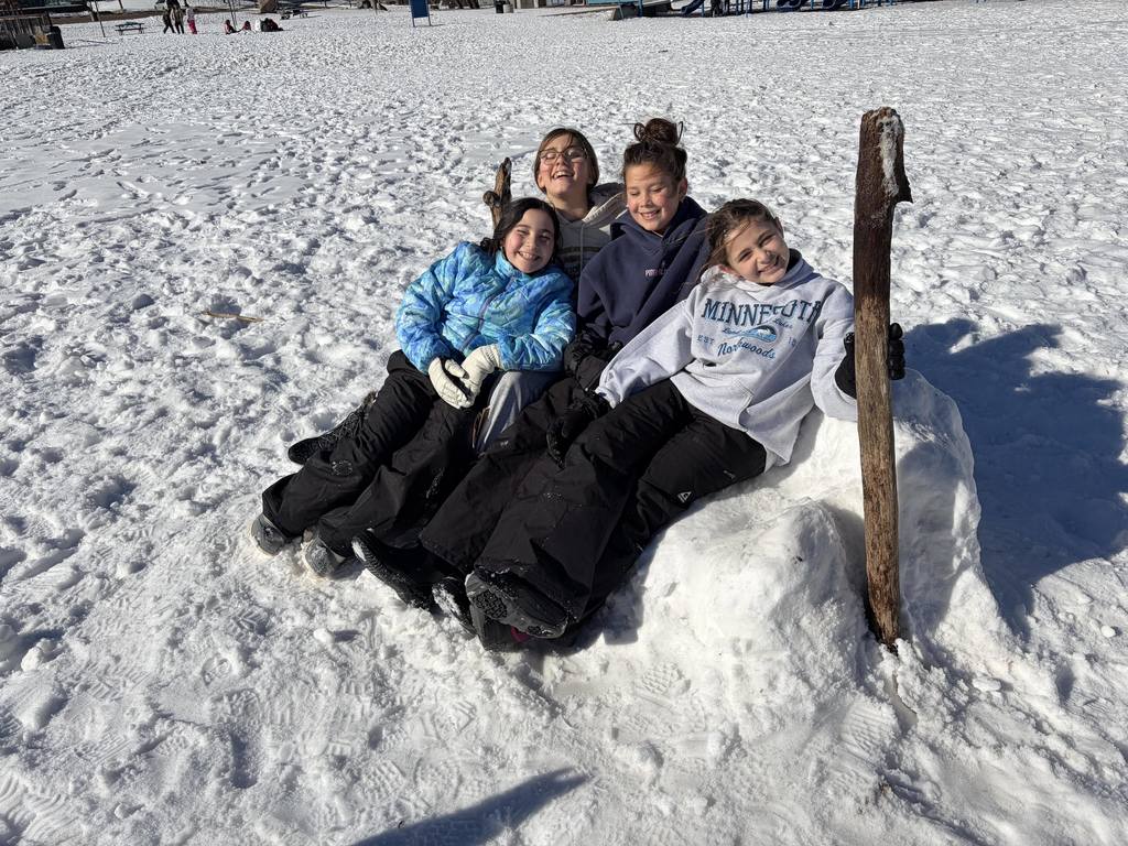 students sit on snow couch