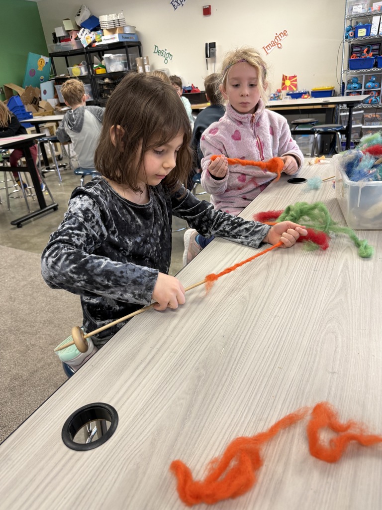 students spin wool