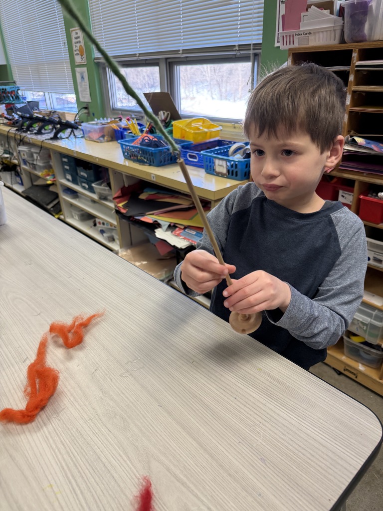 student spins wool