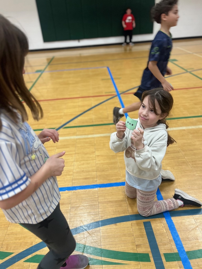 student shows multiplication equation to other student