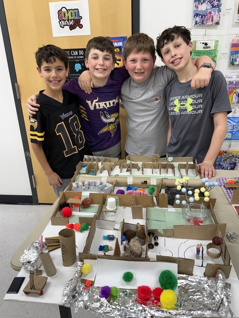 fifth grade students pose with their mars colony model