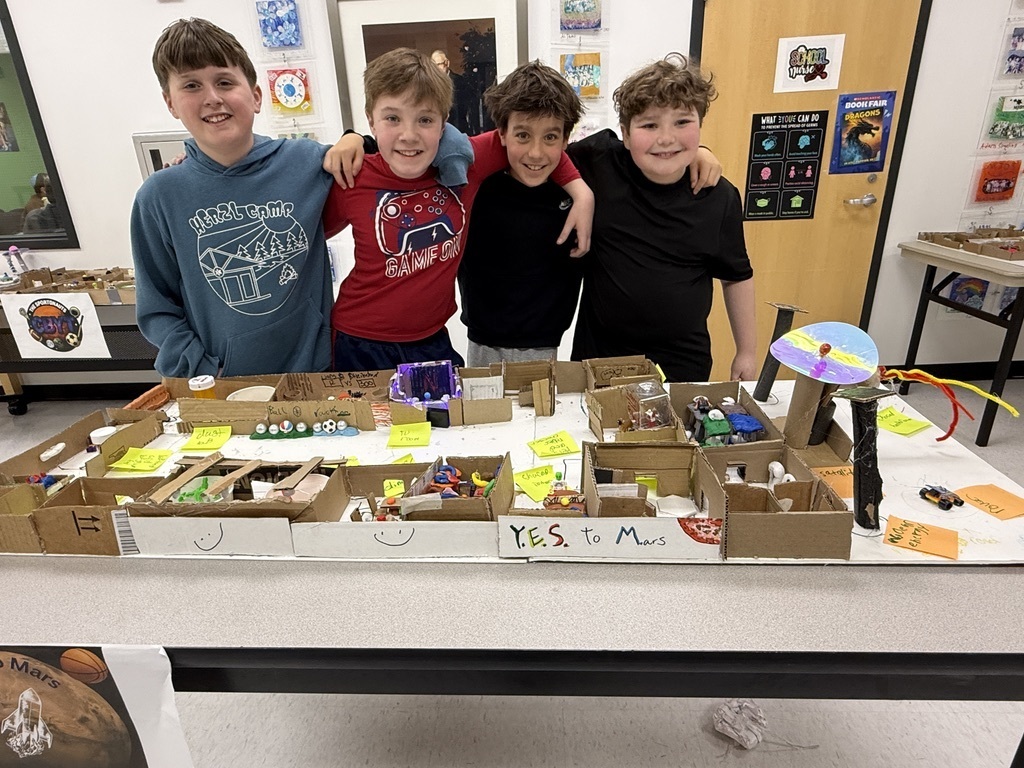 fifth grade students pose with their mars colony model