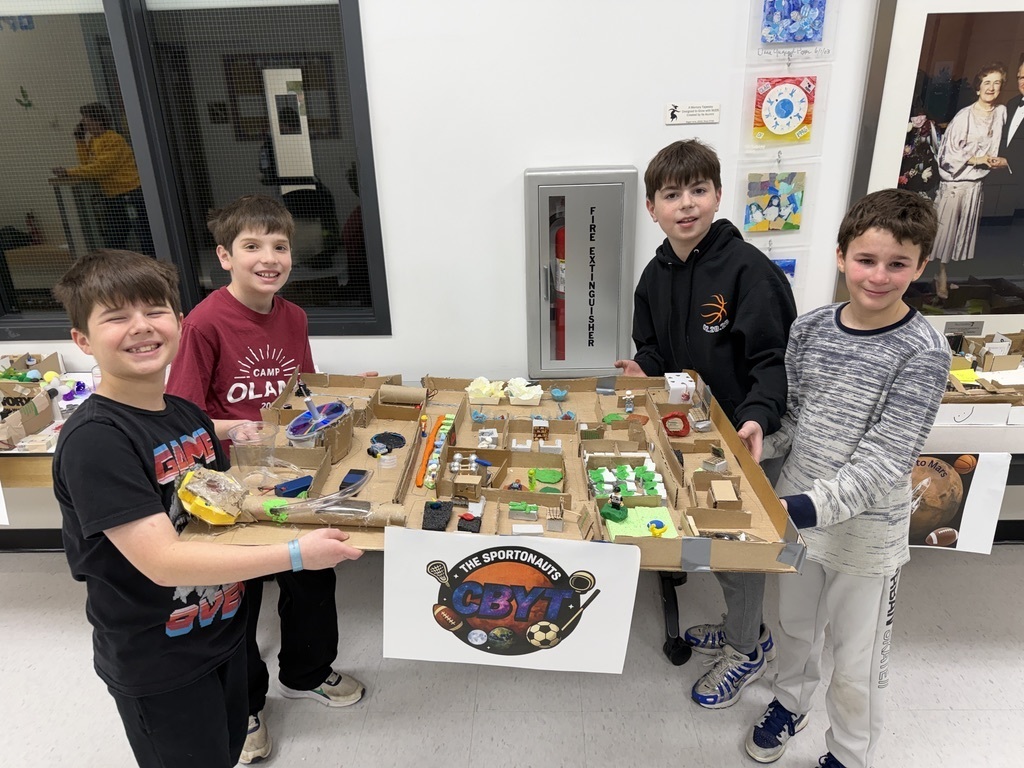 fifth grade students pose with their mars colony model