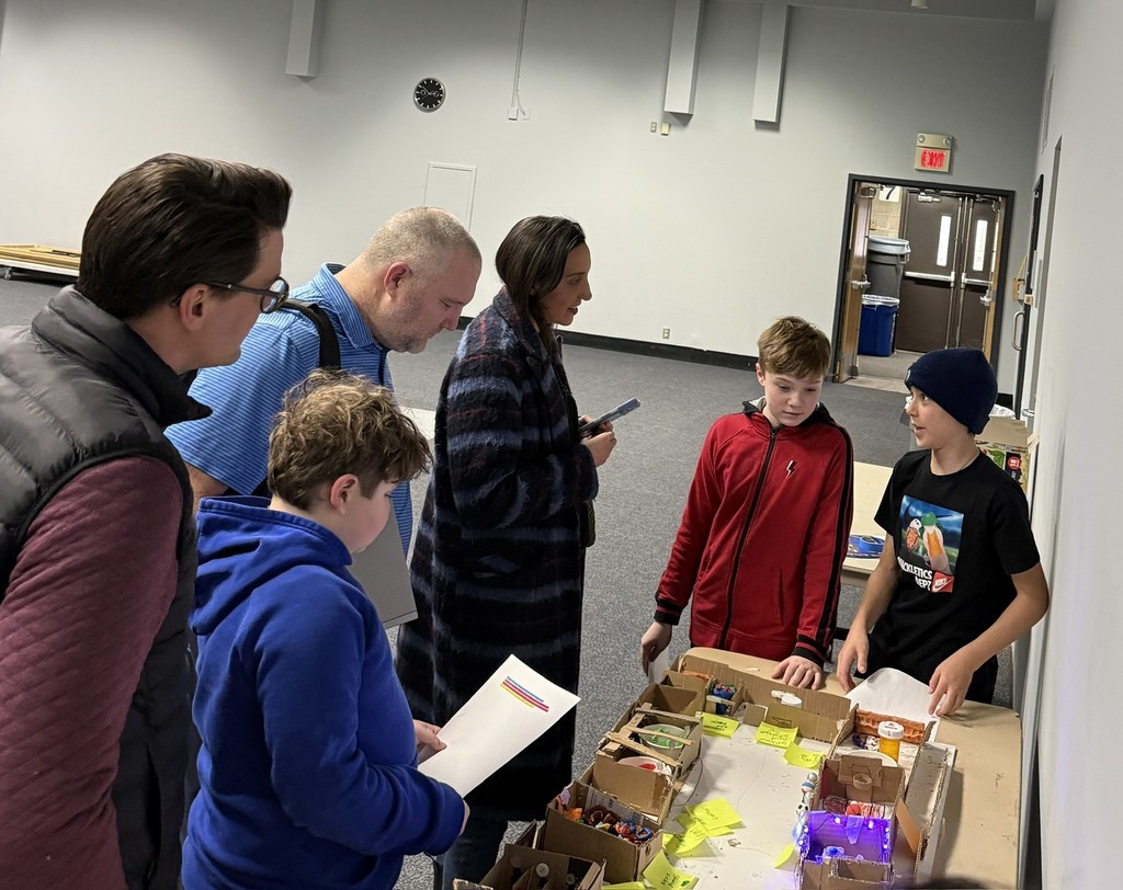 fifth grade students present their mars colony model to parents