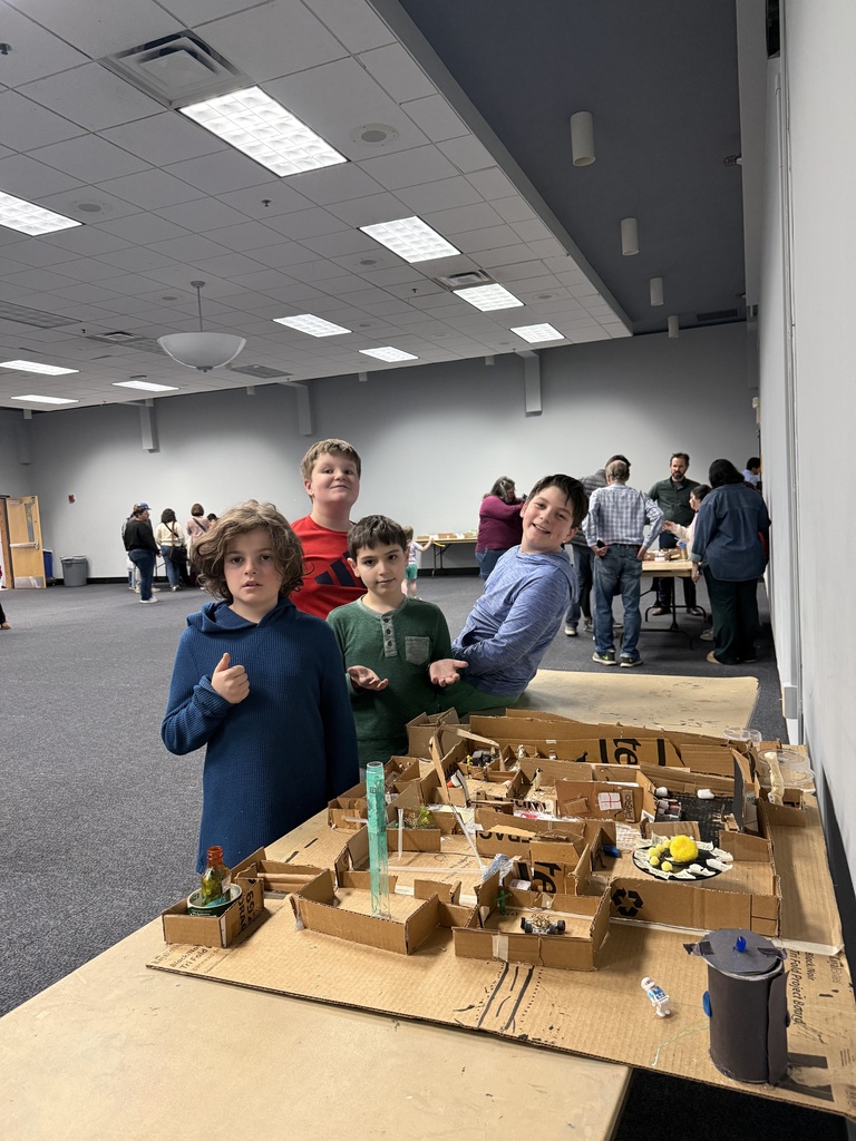 fifth grade students pose with their mars colony model