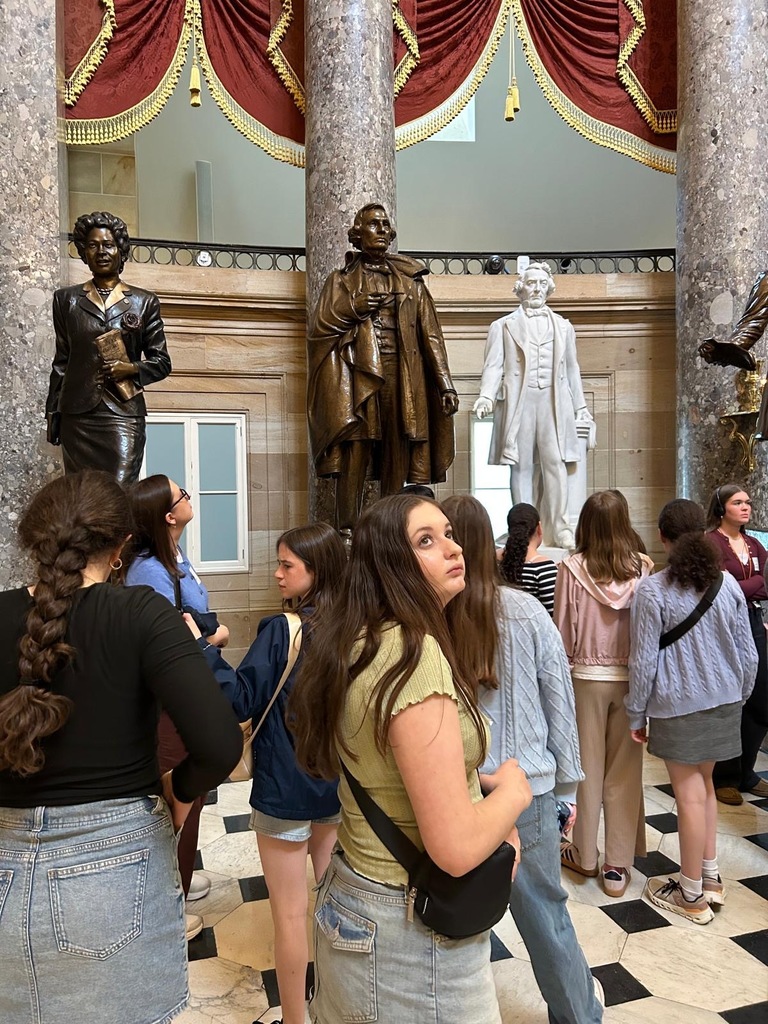 seventh graders look around museum. three statues pictures