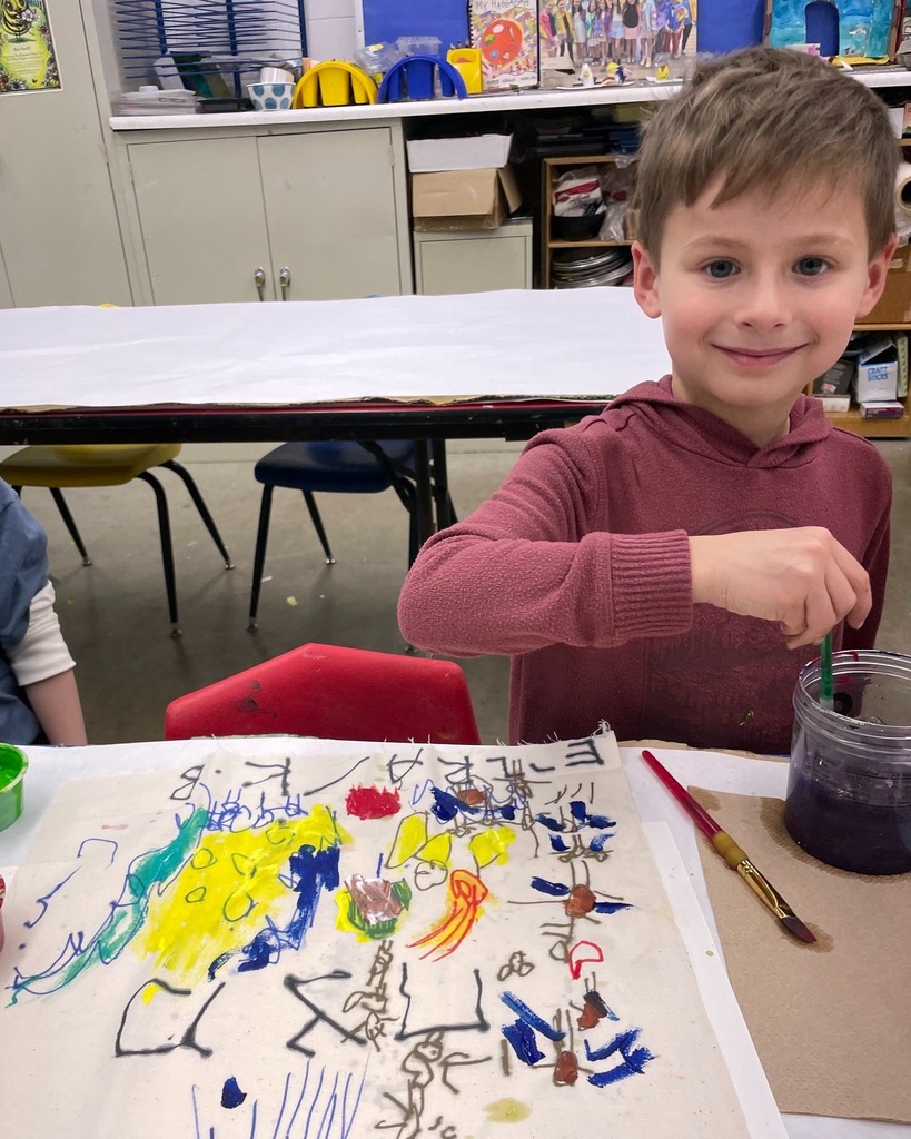 kindergarten student poses with hand-painted matzah cover