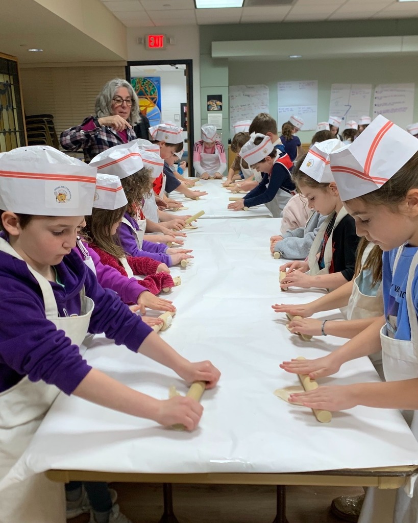 students roll out dough