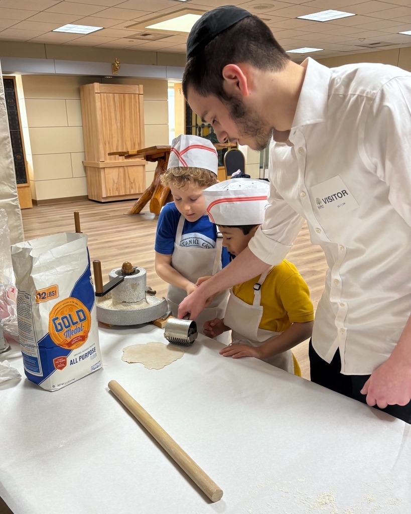 instructor helps students roll/punch holes into dough