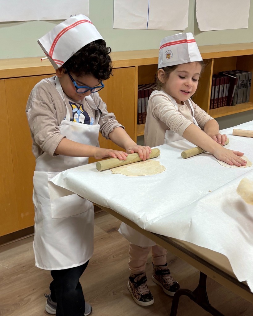 students roll out dough
