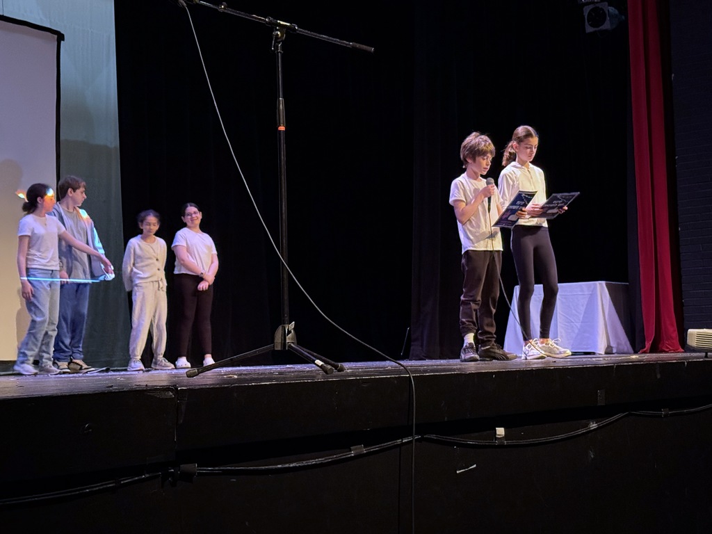 students speak on stage