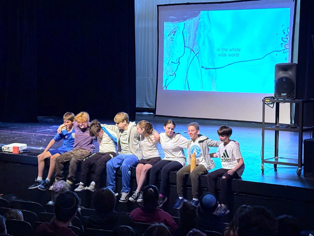 students wrap arms around one another