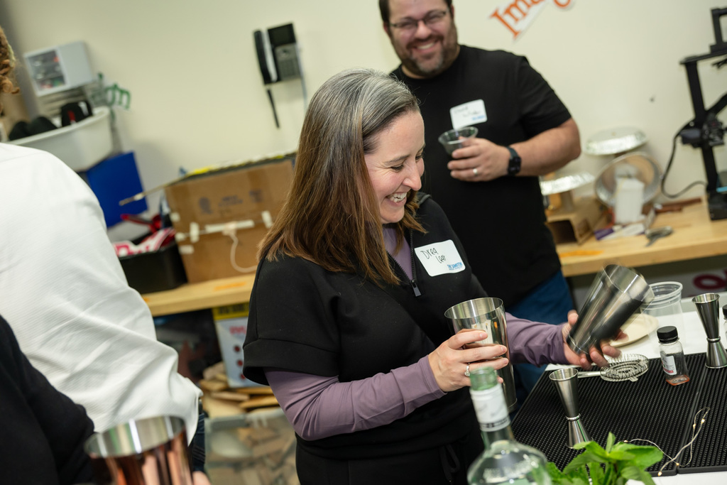 attendee prepares to shake drink in mixology class