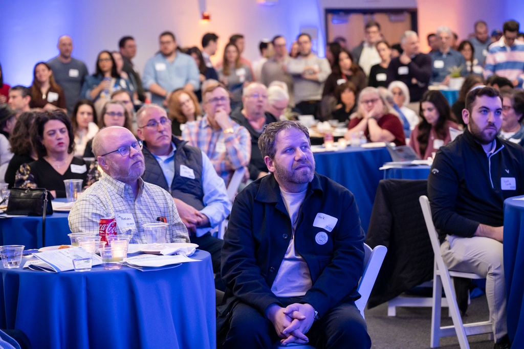 benefit attendees listen to speaker