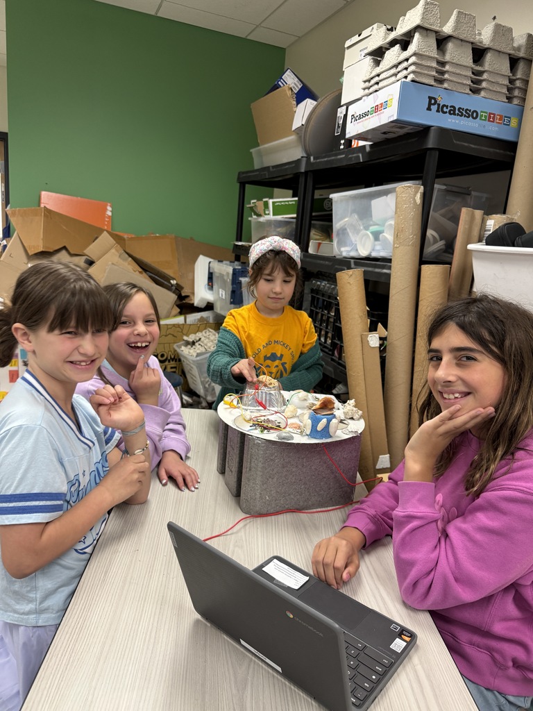 fourth graders show how their instrument works to third graders
