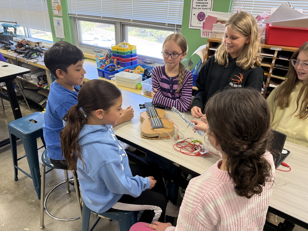 fourth graders show how their instrument works to third graders