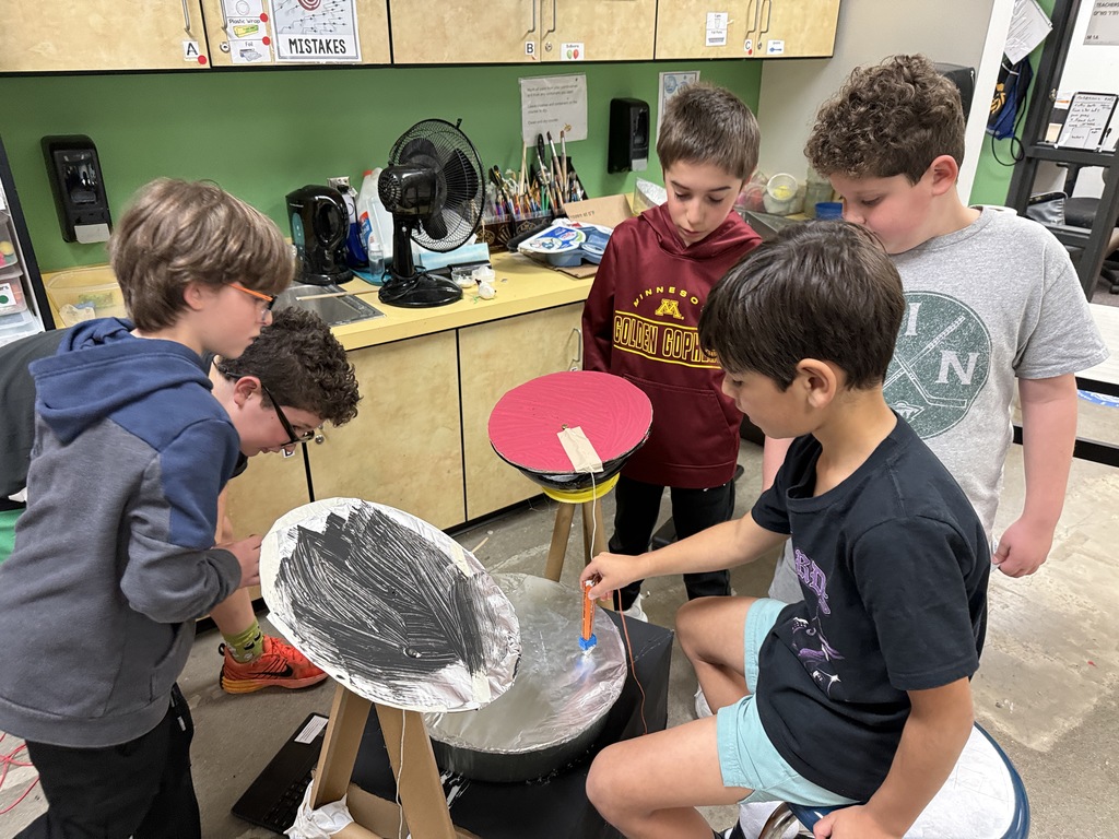 fourth graders show how their instrument works to third graders
