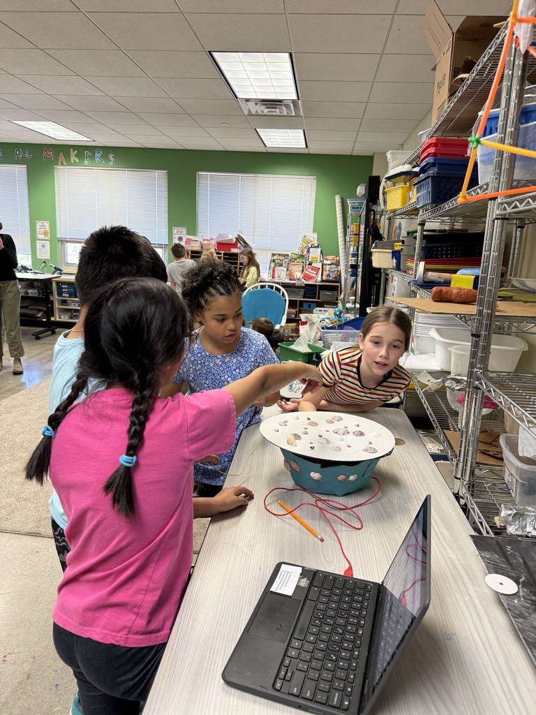 fourth graders show how their instrument works to third graders