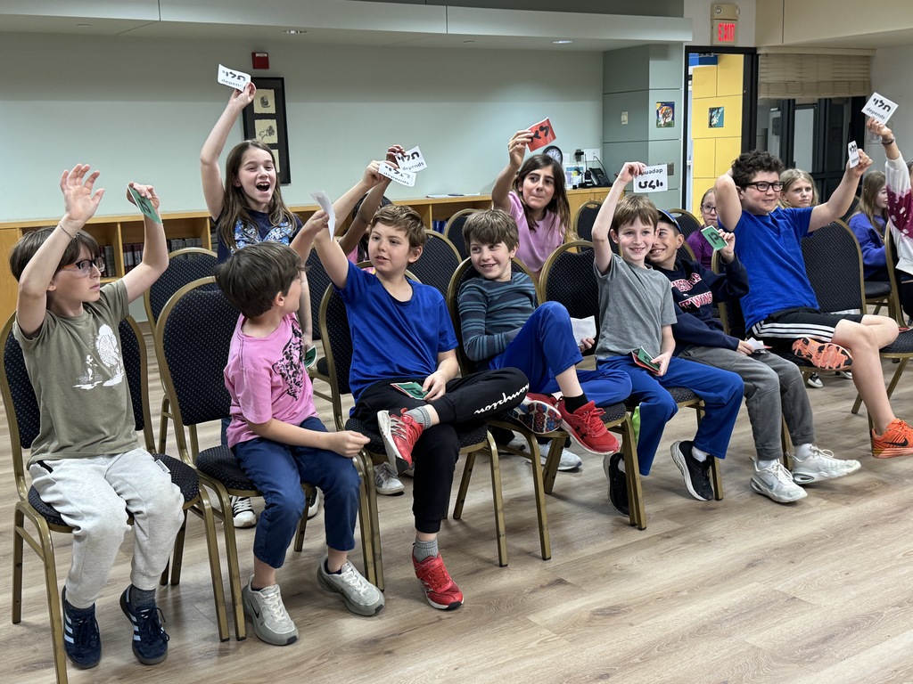 students hold up yes, no, and maybe cards