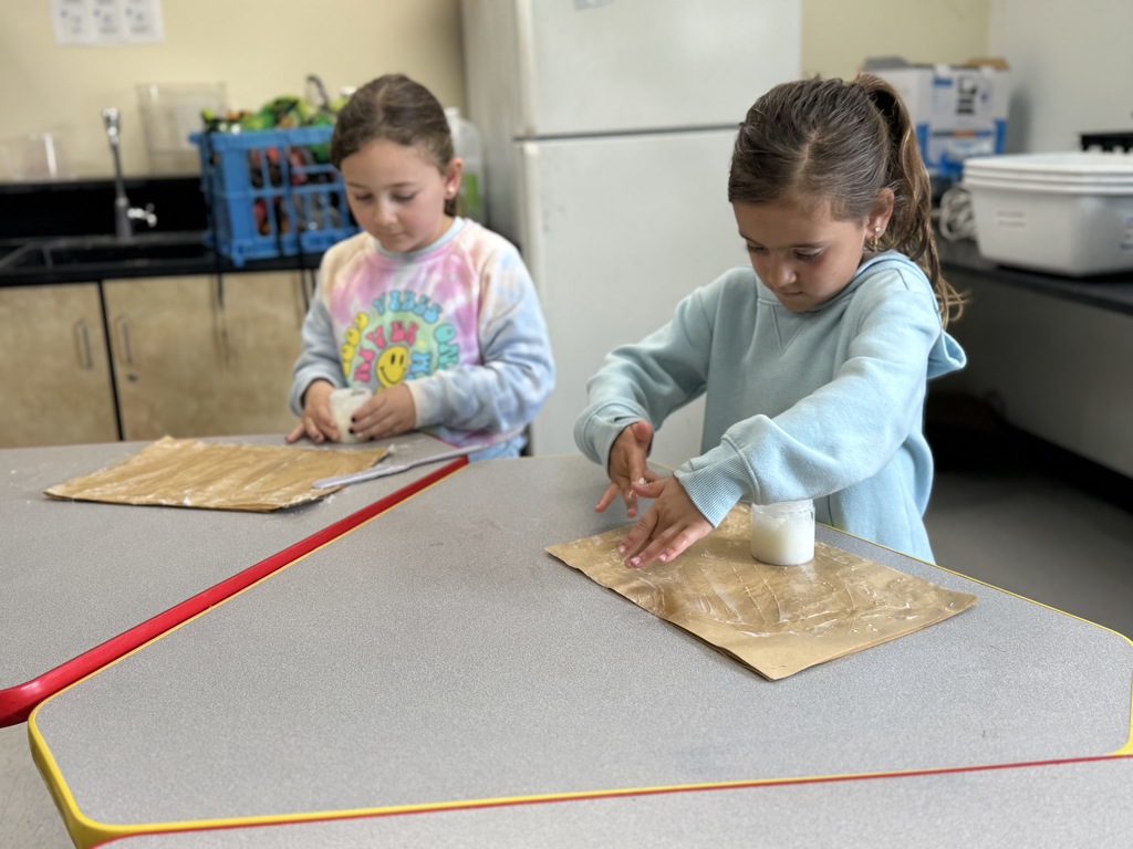 students add cream into jars