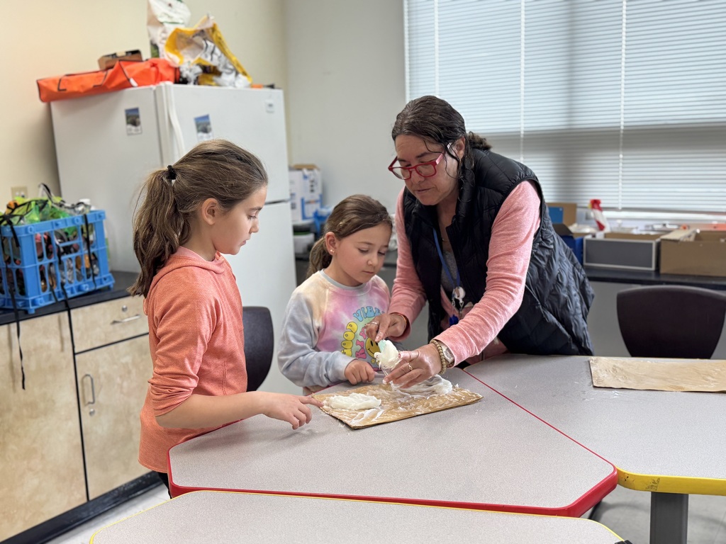 teacher helps student put cream in jars