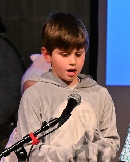 kid speaks into microphone