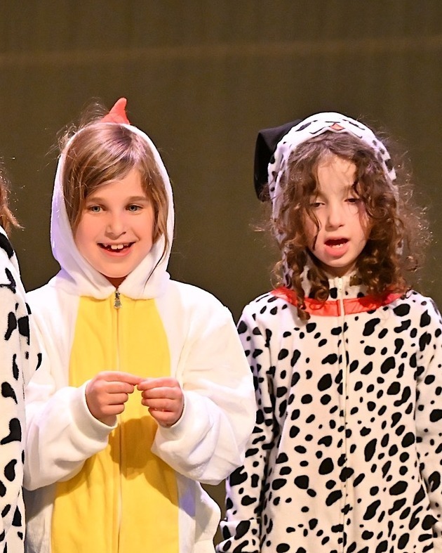 kids dressed as chicken and spotted dog onstage