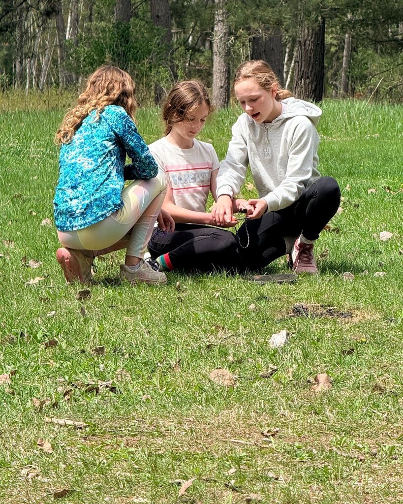 sixth graders work together to start fire