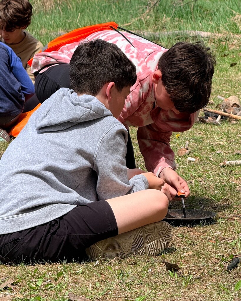sixth graders work together to start fire