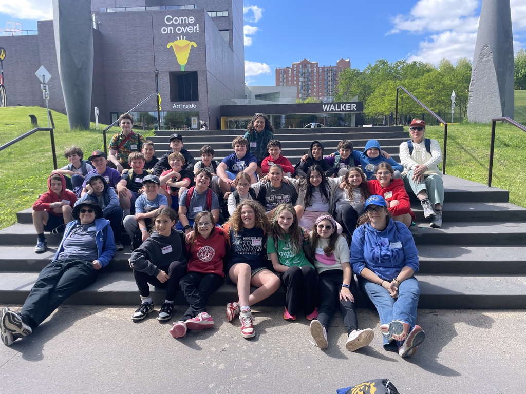 fifth graders and chaperones pose on steps at Walker Art Museum