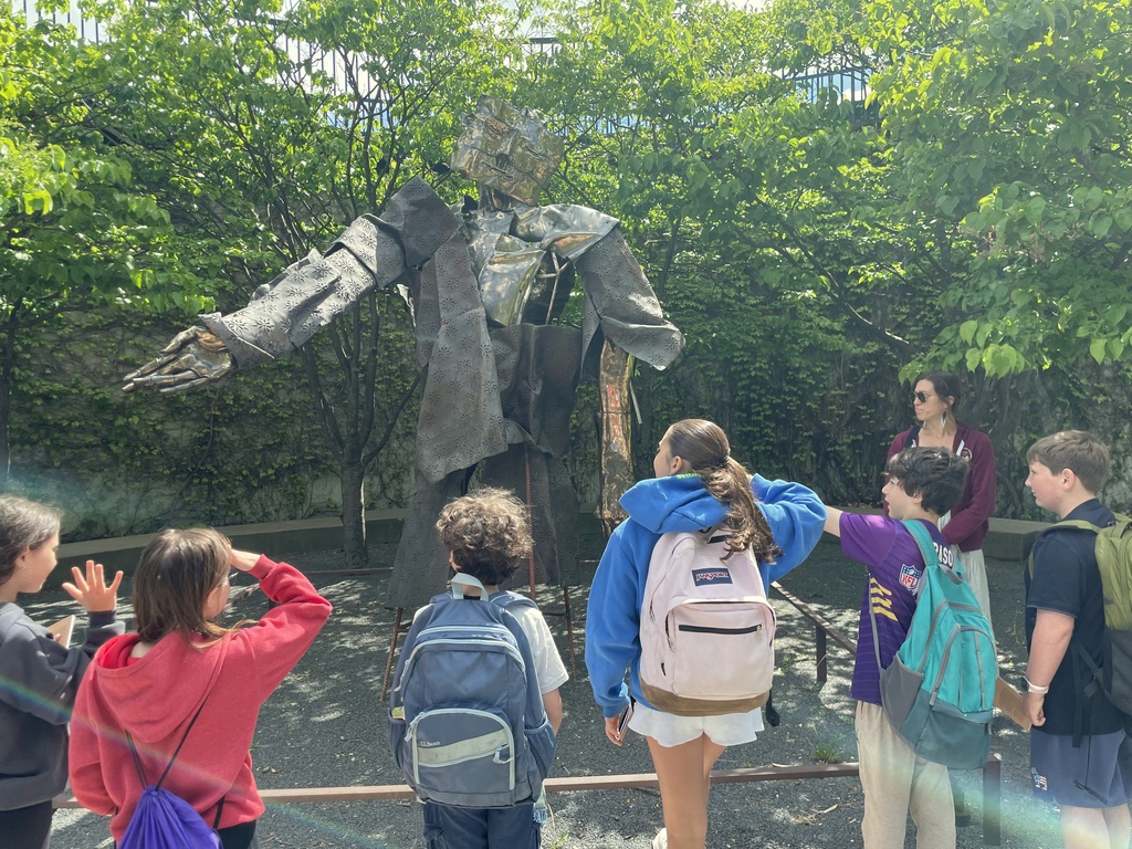 students look at Hephaestus sculpture