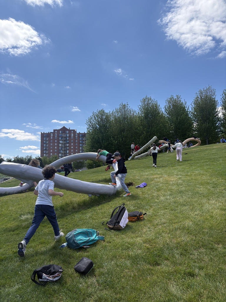 fifth graders run up hill to Privileged Points sculptures
