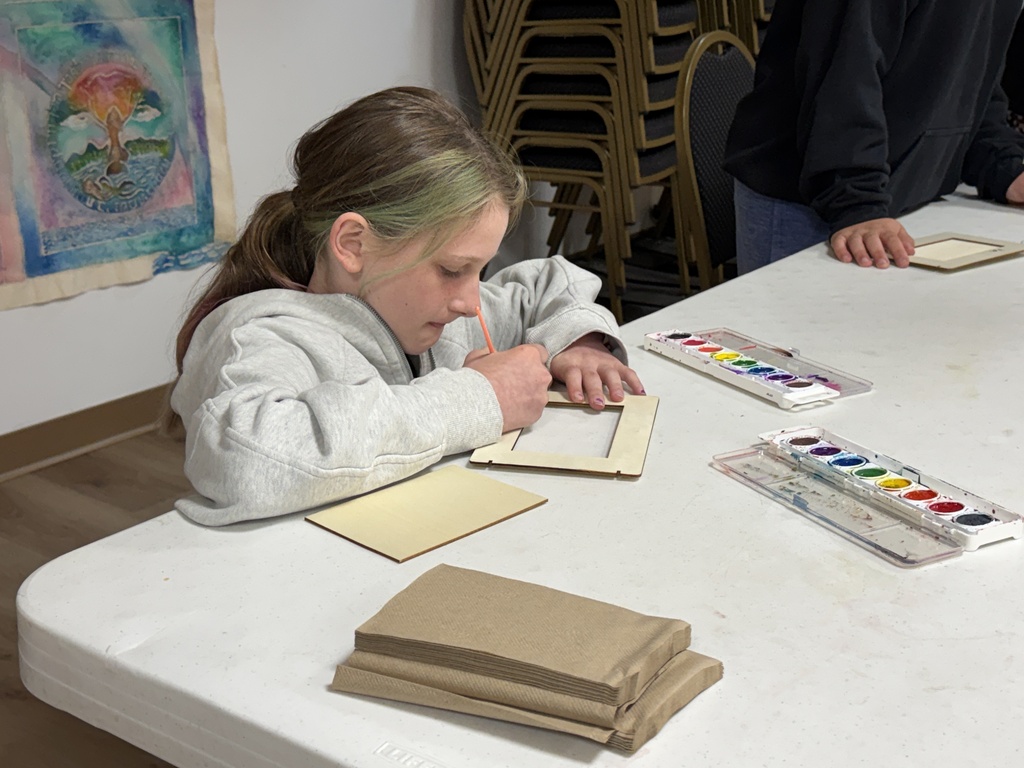 student paints frames