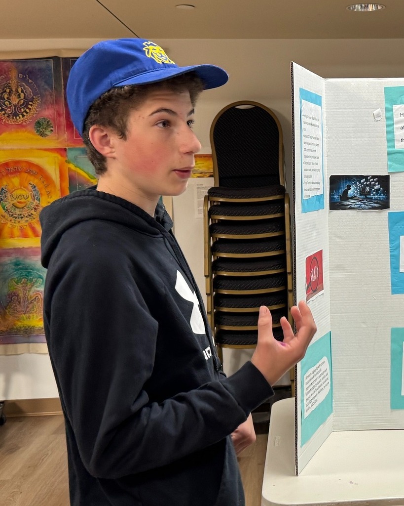 student presents poster with poster board