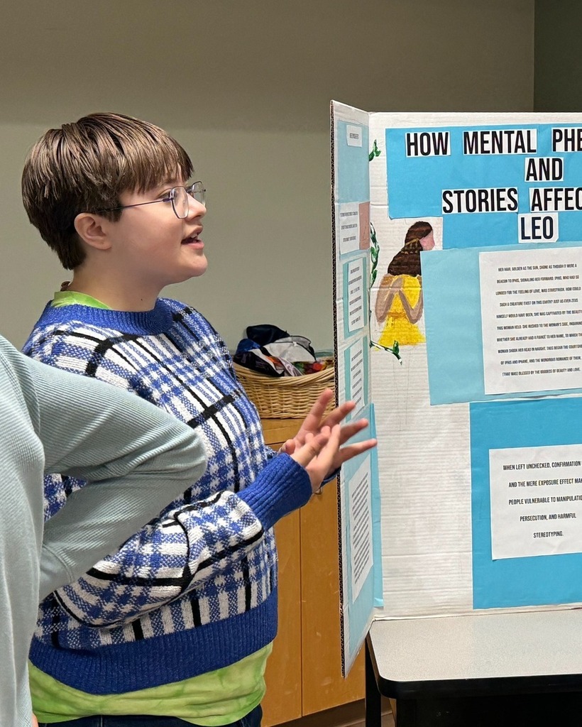 student presents poster with poster board
