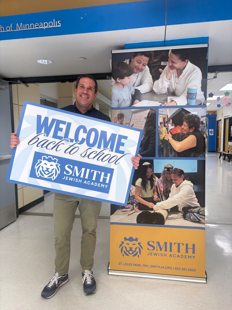Nathan Meyer with Smith Jewish Academy banner and sign