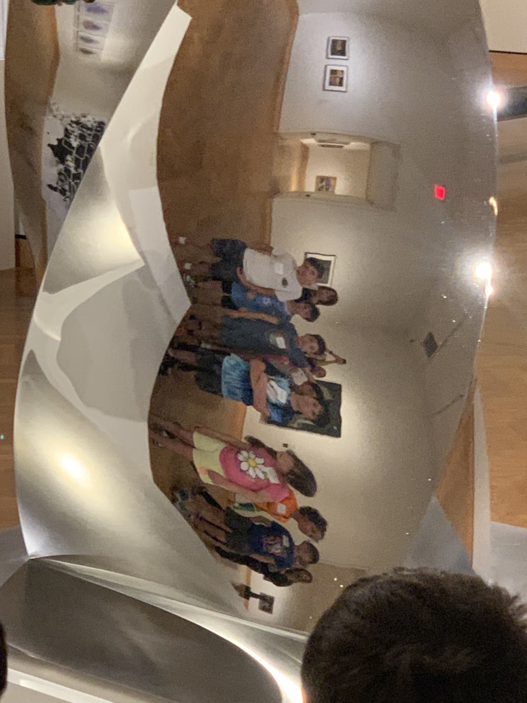 students’ sideways reflection in mirror sculpture