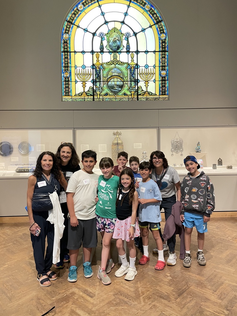 students under stained glass window in Harold and Mickey Smith Gallery of Jewish Arts and Culture