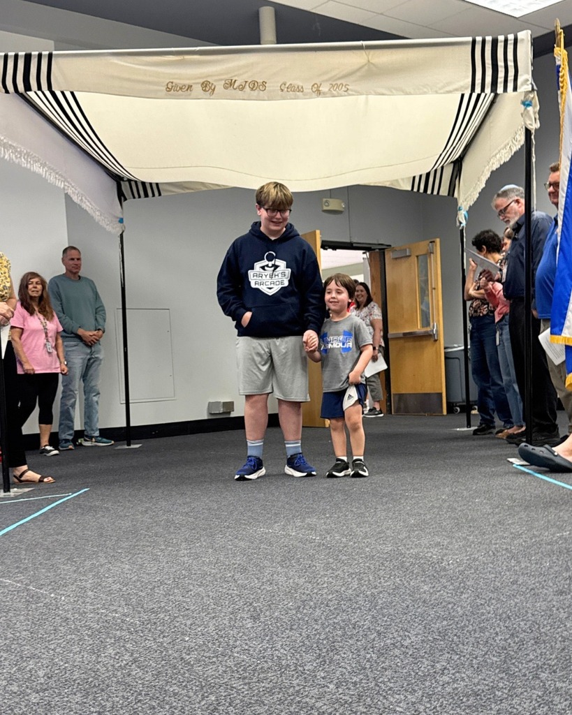 kindergartner with eighth grader under chuppah