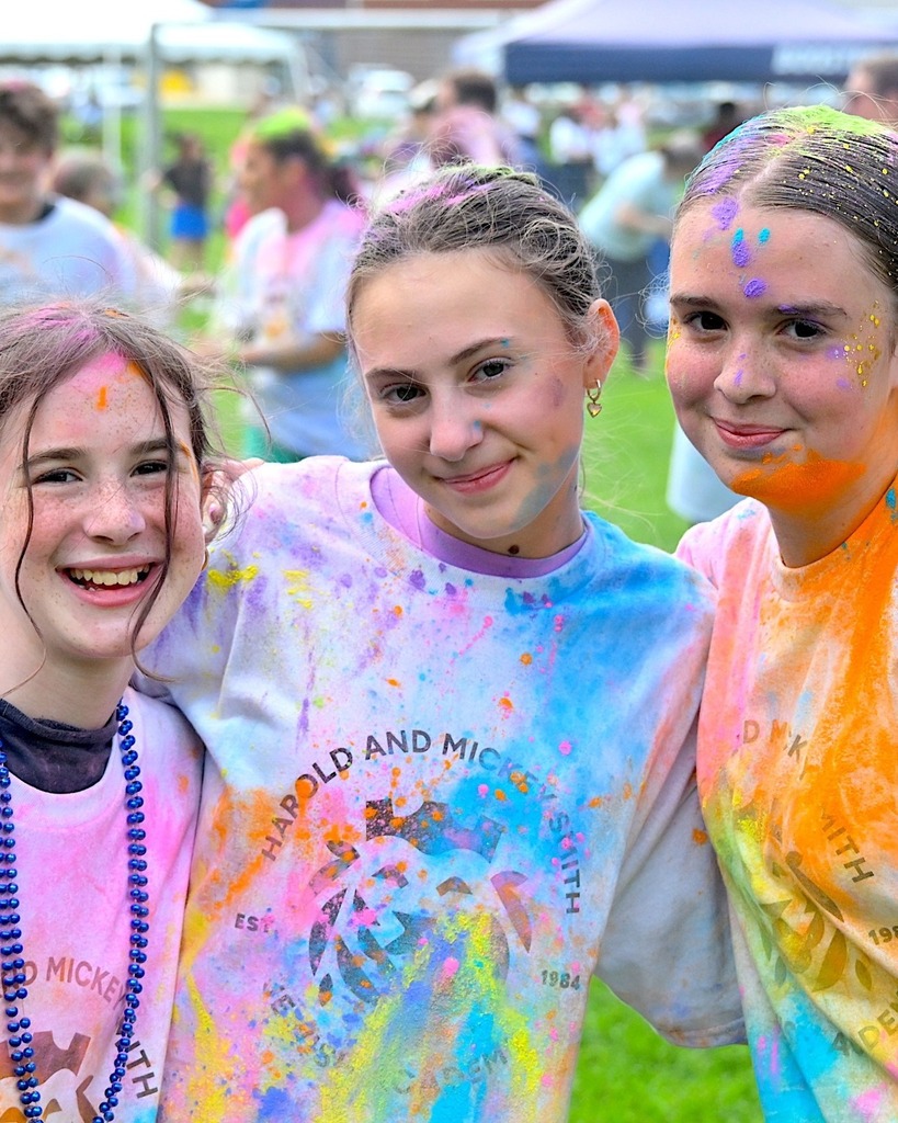 students covered in colorful chalk