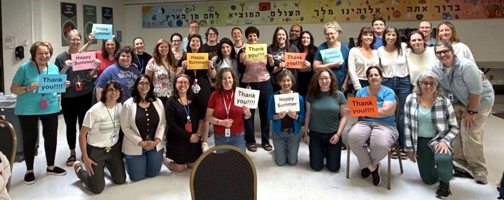 faculty group picture holding signs that say thank you and happy summer