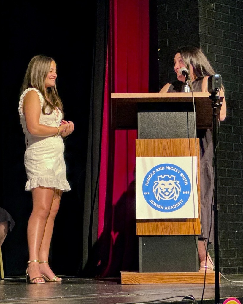 teacher speaks to graduating student