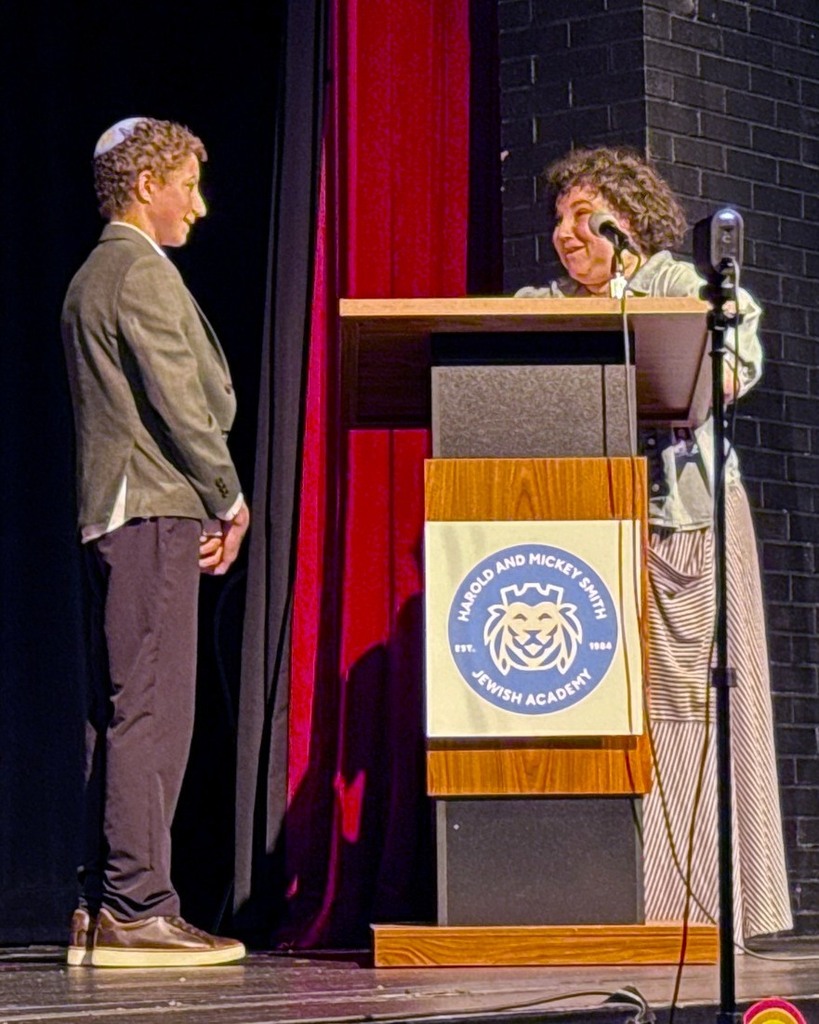 teacher speaks to graduating student