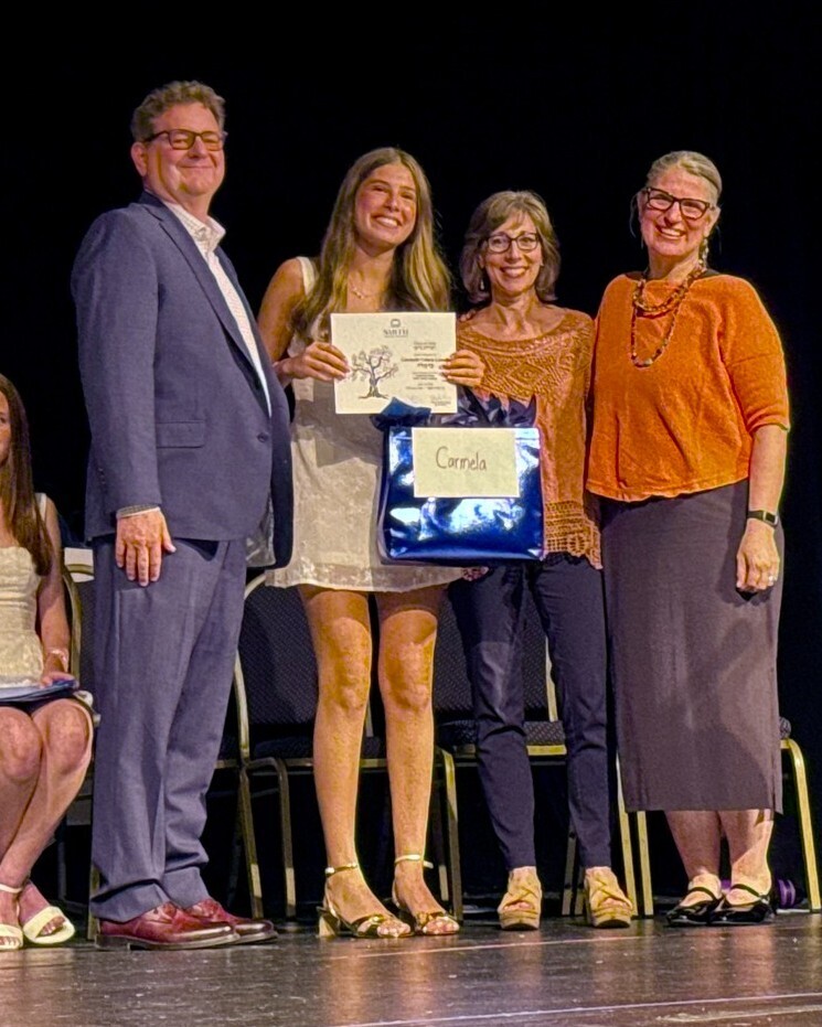 graduating student with diploma and administrators
