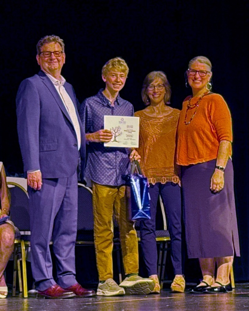 graduating student with diploma and administrators