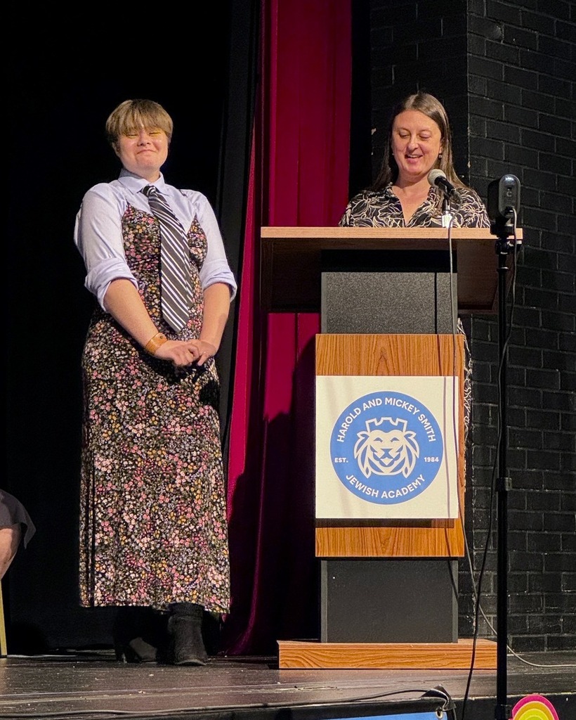 teacher speaks to graduating student