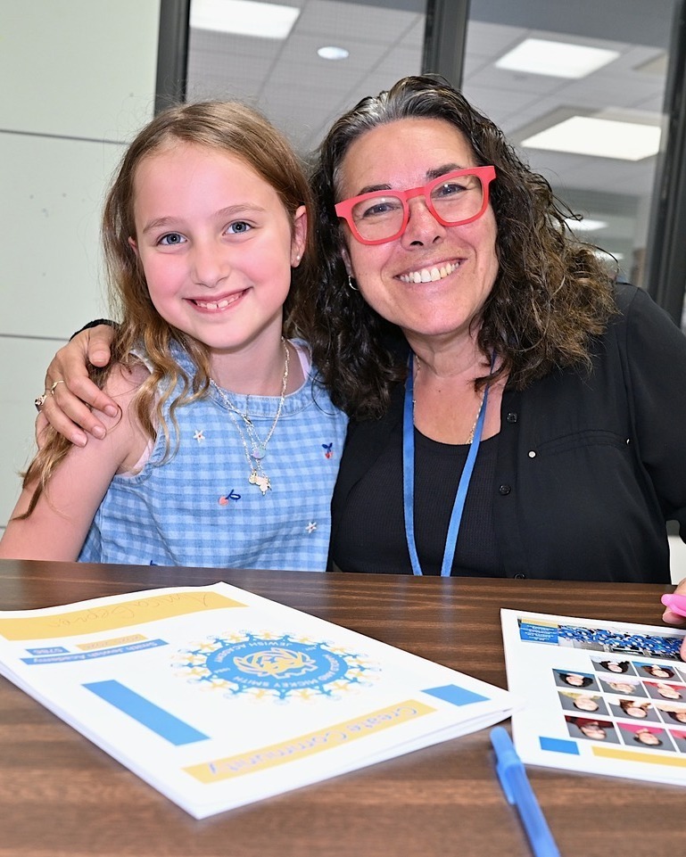 teacher and student with yearbooks