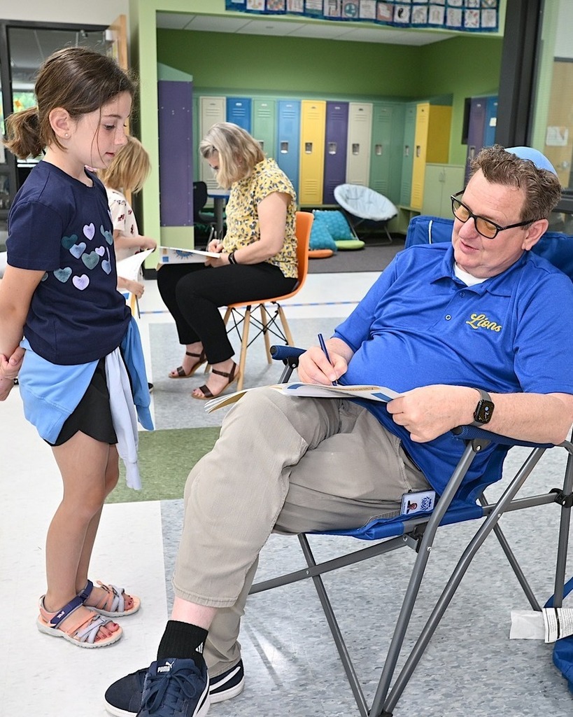Dr. Dan signs a student's yearbook